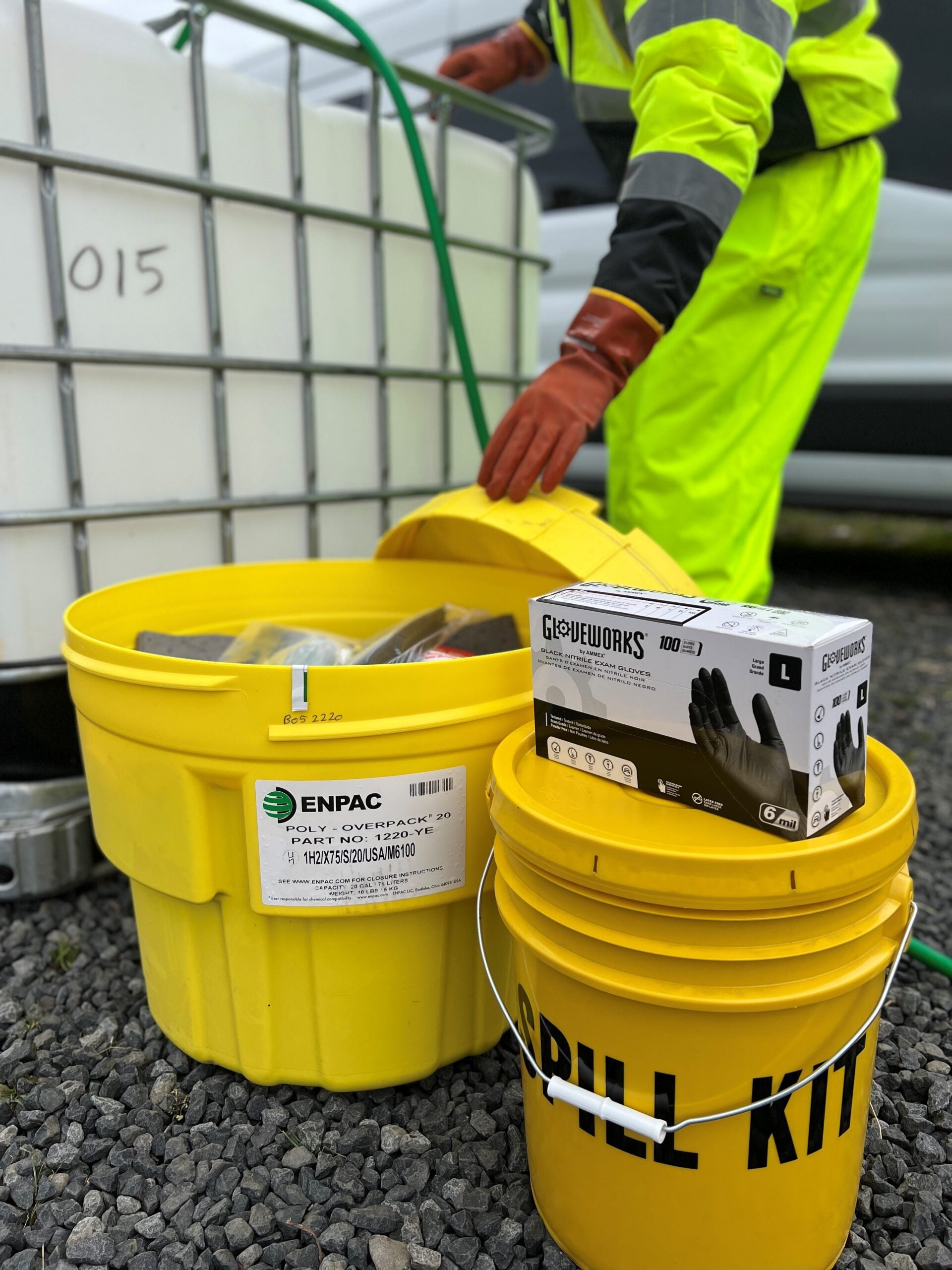 Worker using protective equipment beside workplace safety supplies